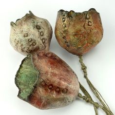 three different colored rocks on a white surface