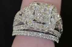 a woman's hand with two diamond rings on it