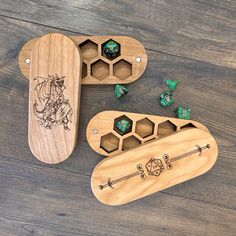 three wooden games pieces with dices in them on a wood table next to each other