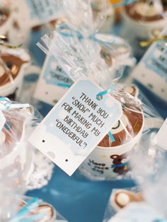 small cupcakes wrapped in plastic wrappers with a sign on them that says thank you so much each morning for making something wonderful