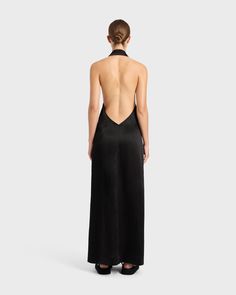 Final Sale 50% Off. This Garment Cannot be Returned or Exchanged. The Faro Halterneck Maxi Dress in Black is cut from a sustainable Linen Satin Blend. This luxe fabric has a sheen that make it perfect for event dressing and elegant evenings out. The long dress features a sensuous, deep plunge back. Two panels wrap around the body, with an invisible internal tie and an external tie with long, rouleau strings. Darts in the back help hug the dress to the body. Falls to the floor. Luxury fabric sust Black Halter Maxi Dress, Resort Wear Dresses, Deep Plunge, Halter Maxi Dress, Halter Maxi, Black Halter, Dreamy Dress, Dress Satin, Halter Maxi Dresses