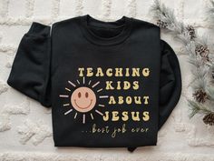 Inspire faith in our "Teaching Kids about Jesus" shirt - a must-have for ministry leaders, ministers, and youth pastors. Elevate your impact in children's ministry with this Christian tee, a blend of comfort and purpose. Make a statement of devotion with our Church Shirt, designed to spark conversations and share the joy of spreading the teachings of Jesus. Embrace the calling with style and comfort - an ideal addition to your ministry wardrobe. Ideal for any situation, a unisex heavy blend crew Childrens Ministry Shirts, Youth Pastor, Church Shirt, About Jesus, Jesus Shirt, Christian Tees, Christian Shirt, Jesus Shirts, Children's Ministry