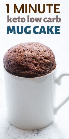 a close up of a cupcake in a mug on a table with the words 1 minute keto low carb muc cake