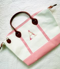 "Adorable monogrammed weekender bag.  Canvas trimmed in pink with faux leather trim.  Single floral letter monogram stitched in custom colors.  Just the right size for overnight or weekend trips.  Detachable shoulder strap included. Perfect gift for Mother's Day, graduation, or birthday. Choose your single alphabet monogram letter. Size approx: 15\" x 20\" x 7\" Heavy-duty double zipper. Water-resistant lining. Pair it with a matching canvas toiletry bag for the total package- https://www.etsy.com/MissWhitesParty/listing/1107668441/monogrammed-canvas-make-up-bag?utm_source=Copy&utm_medium=ListingManager&utm_campaign=Share&utm_term=so.lmsm&share_time=1636560312853 *Please note-each the monogram will be different in size. The embroidered area could be smaller or larger than the photo due to Monogrammed Duffle Bag, Canvas Weekender Bag, Alphabet Monogram, Canvas Duffle Bag, Overnight Travel Bag, Holdall Bag, Monogram Towels, Monogrammed Gifts, Letter Monogram