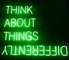 a green neon sign that says think about things at the bottom and below it are words