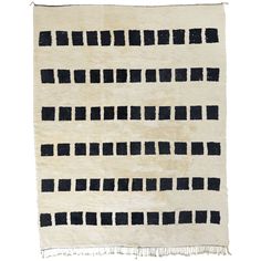 a black and white rug with small squares on the bottom, in various sizes and colors