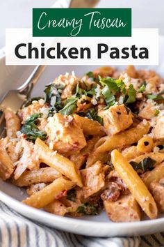 chicken pasta with spinach and parmesan cheese in a white bowl on a striped cloth