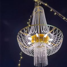 a chandelier hanging from the ceiling with lights around it