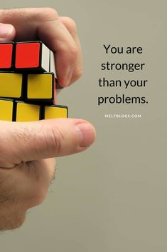 a person holding a rubel cube with the words, you are stronger than your problems