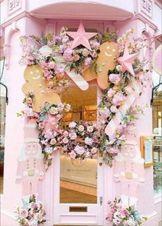 a pink door decorated with flowers and teddy bears