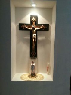 a crucifix in a white walled room