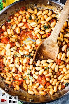 a skillet filled with beans and tomatoes