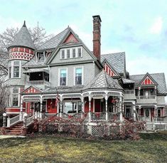 an old victorian house with red and white trim