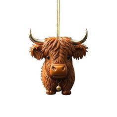 a brown cow ornament hanging from a gold chain