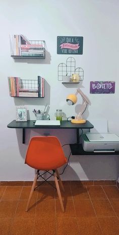 an orange chair sitting in front of a desk