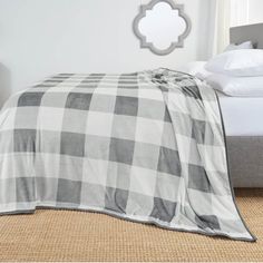 a bed with a plaid blanket on top of it