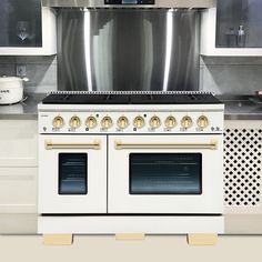 a white stove top oven sitting inside of a kitchen