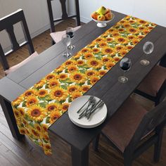 the table is set with sunflowers and silverware