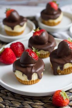 several cupcakes with chocolate frosting and strawberries