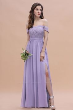 a woman in a long purple dress posing for the camera