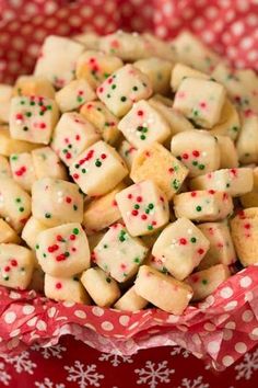 a bowl filled with white and green sugar cubes on top of a red polka dot cloth