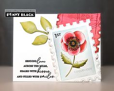 a close up of a card with a stamp on it and a flower in the middle