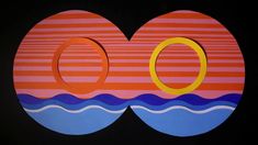 an image of two circles in the middle of a black background with water and orange stripes