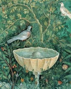 two birds sitting on top of a bird bath