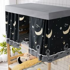 a child's bunk bed with space themed curtains