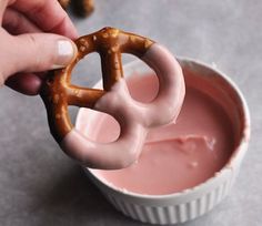 a person holding a pretzel in their hand