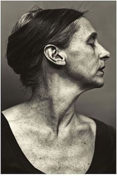 black and white photograph of an older woman with wrinkles on her face, looking to the side