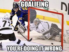 the hockey player is trying to block the goalie