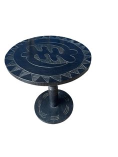 an artistically designed table with blue paint on the top and silver decoration around it