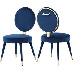 two blue chairs with gold legs and a clock on the back one chair is round