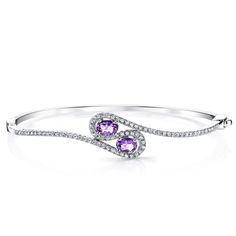 Amethyst fields Take a trip to the lavender fields of Provence with the breathtaking beauty of the Peora natural Amethyst. This classic bracelet features oval shape Peora natural Amethyst gemstones in .925 sterling silver. Our natural Amethyst gemstones are a unique gift from nature. By cutting them in a way that respects the rough's natural radiance, we ignite their inherent intensity and maximize their brilliance to deliver on our signature Peora standard. Handcrafted in pure .925 sterling silver goodness, this bracelet has been carefully coated in an elegant rhodium finish. Our artisans are expertly trained in this process which fortifies the bracelet's strength, shine and brilliance. Looking for an anniversary or engagement present? Our concierge stylists are here to help with all of y Oval Bangle, Amethyst Bangle, Jewelry Questions, Peridot Bracelet, Classic Bracelets, Expensive Jewelry, Peridot Gemstone, Swiss Blue Topaz, Gemstone Bracelets