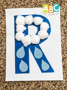 the letter r is made out of foam and pom - poms on a piece of paper