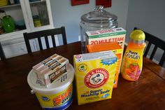 the table is covered with different types of household cleaning products and detergent on it