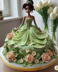 there is a cake that looks like a princess sitting on a table with flowers in front of it