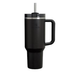 the black travel mug has a handle and is holding a cup with a straw in it