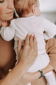 a woman holding a baby in her arms