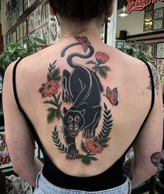 a woman with a black panther tattoo on her back