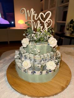 a wedding cake decorated with flowers and mr and mrs letters