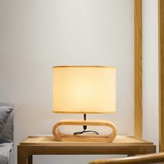 a wooden table with a lamp on it