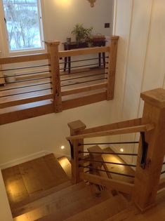 two wooden banisters in front of a window on the side of a staircase