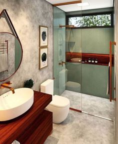 a bathroom with a sink, toilet and shower stall in the middle of the room