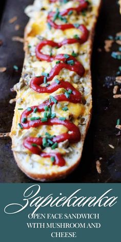 a long piece of bread with cheese and peppers on it