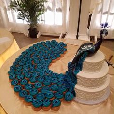 there is a peacock cake on the table