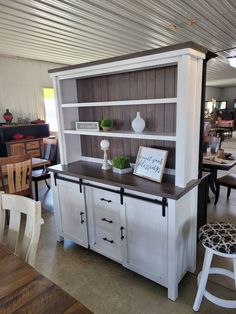 a dining room table and chairs with a hutch in the middle, on display