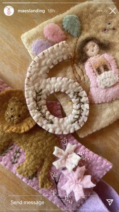 three handmade items are sitting on a table together, one has a teddy bear and the other is a cat