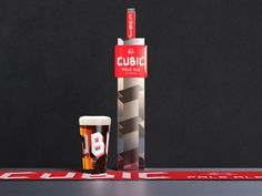 a beer glass next to a sign that says cubbie on the front and side